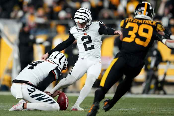 Cincinnati Bengals place kicker Evan McPherson (2) kicks a field goal as Cincinnati Bengals punter Drue Chrisman (4) holds in the third quarter during a Week 11 NFL game against the Pittsburgh Steelers, Sunday, Nov. 20, 2022, at Acrisure Stadium in Pittsburgh, Pa. The Cincinnati Bengals won, 37-30. Nfl Cincinnati Bengals At Pittsburgh Steelers Nov 20 0071